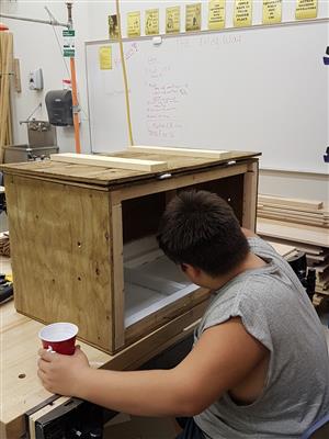Shop student painting the interior of his chest  