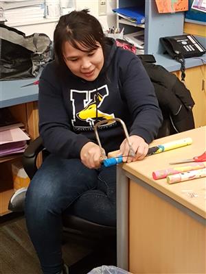 Teacher working on an ice fishing pole  