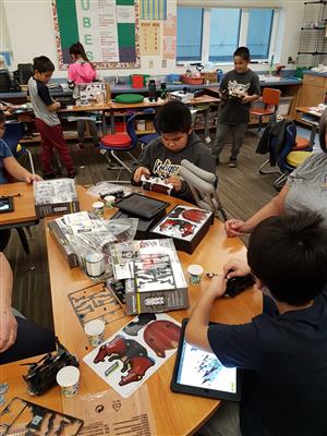 classroom with students building robot kits  