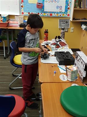 Boy working on his robot 
