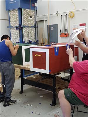 shop class working on storage chest 