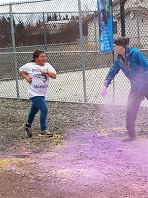 Girl running through colored powder 